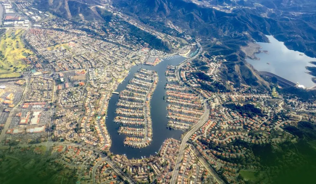 Barrister Suites Office Lease Aerial view of a suburban neighborhood built around a series of interconnected lakes and canals, surrounded by hills, with residential homes and streets densely packed around the water.