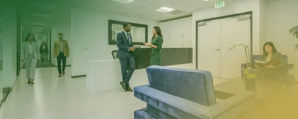 Barrister Suites Office Lease Professional people interacting in a modern office lobby.