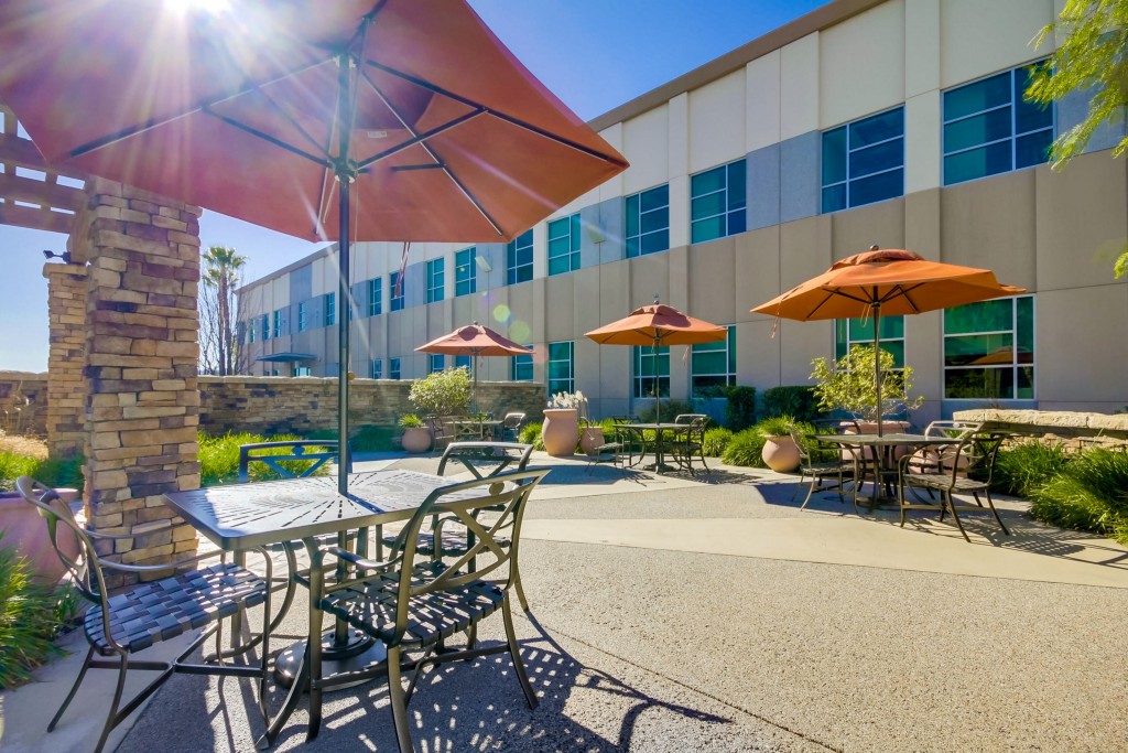 outside Barrister's valencia location chairs with orange umbrellas