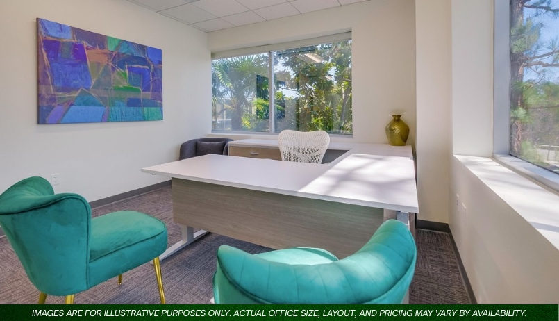 Barrister Suites Office Lease Modern office with a white desk, mesh chair, and two teal velvet chairs. Large windows let in sunlight, and abstract art hangs on the wall. A green vase sits on a side table near the window.