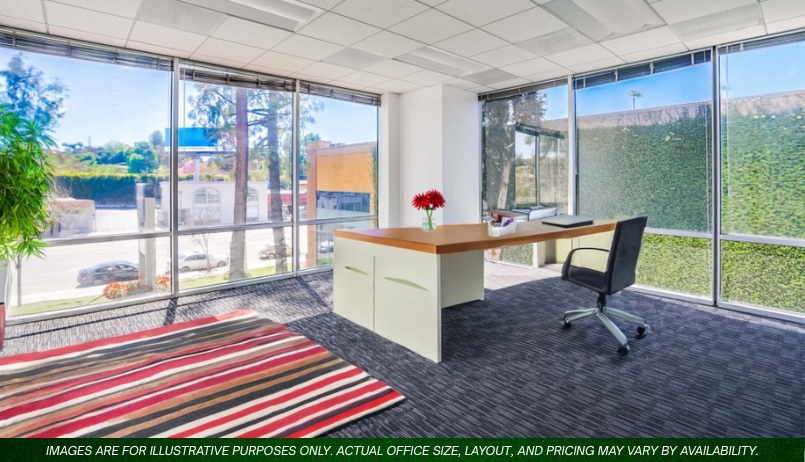 Barrister Suites Office Lease Modern office with large windows, a wooden desk with a red flower vase, a black chair, and a striped rug. Sunlight streams in, and greenery is visible outside. Text along the bottom reads: “Images are for illustrative purposes only.”.