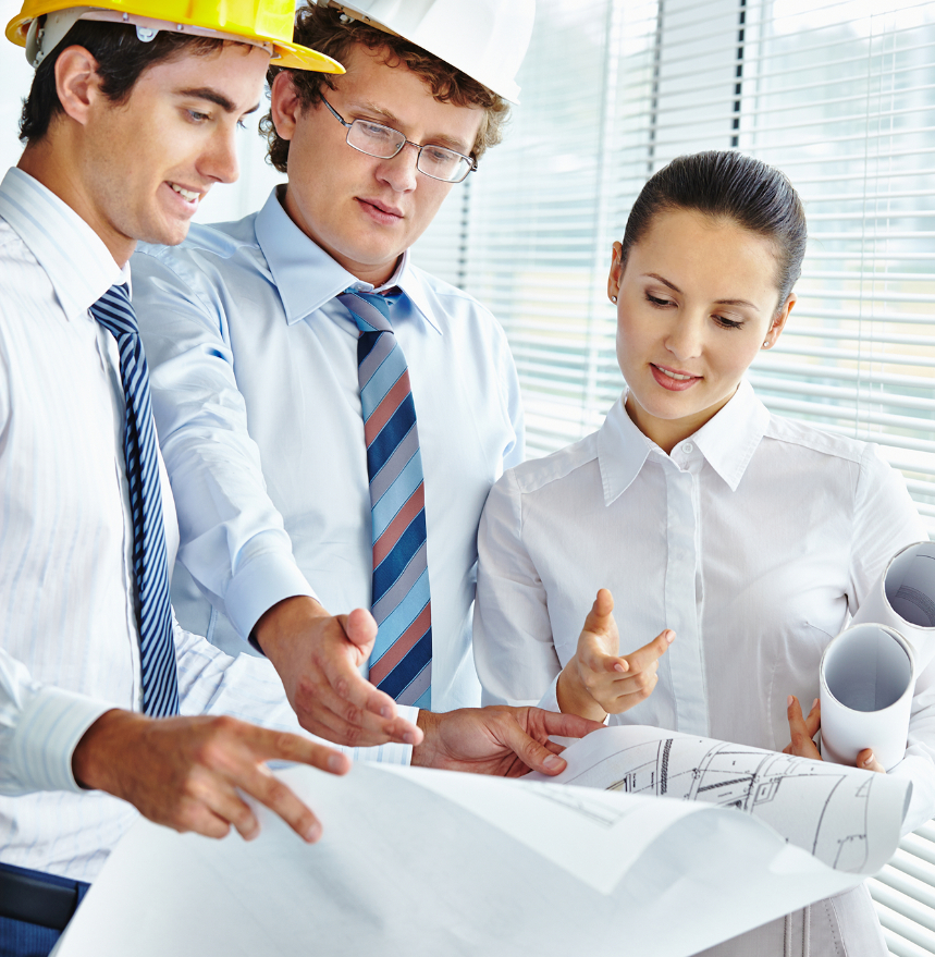 Barrister Suites Office Lease Three professionals, two men in hard hats and ties and a woman holding blueprints, are reviewing architectural plans together in a bright office with large windows and blinds.