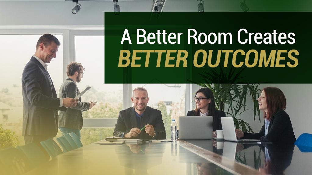 Barrister Suites Office Lease Four professionally dressed people sit and stand around a conference table in a bright office, collaborating. Text overlay reads: A Better Room Creates Better Outcomes.