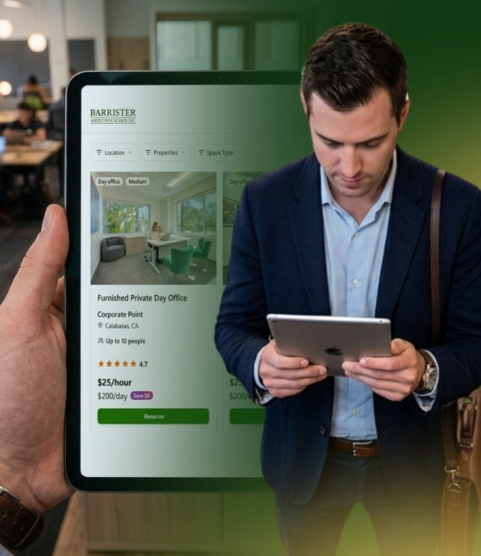 Barrister Suites Office Lease A man in business attire uses a tablet, while someone in the background holds another tablet displaying a workspace booking website for furnished office rentals.