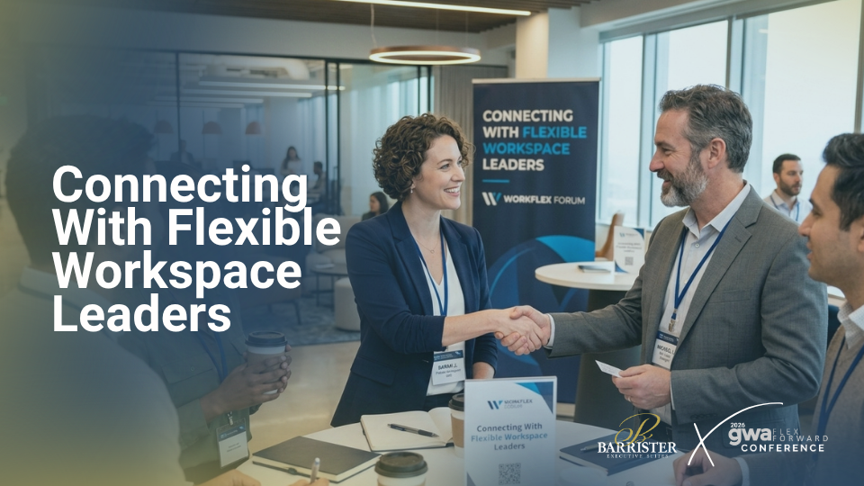 Barrister Suites Office Lease Business professionals in formal attire shake hands and smile during a networking event, with a sign behind them reading Connecting With Flexible Workspace Leaders. Tables, laptops, and conference badges are visible.