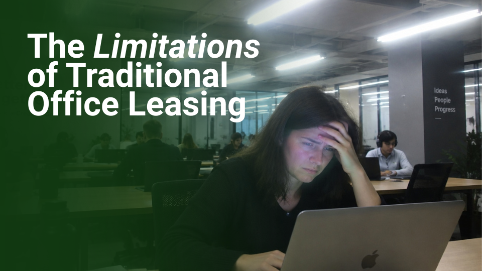Barrister Suites Office Lease A woman looks stressed while working on a laptop in a modern office. The text reads, The Limitations of Traditional Office Leasing. Other people are working in the background.